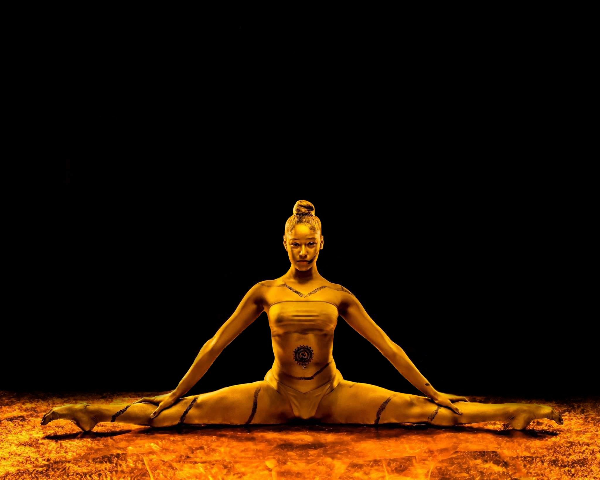 Azra Dewan in gold body art, seated pose